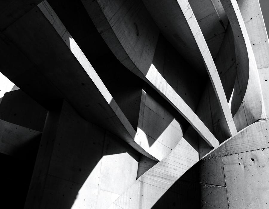 Curved concrete architecture in strong light and shadow